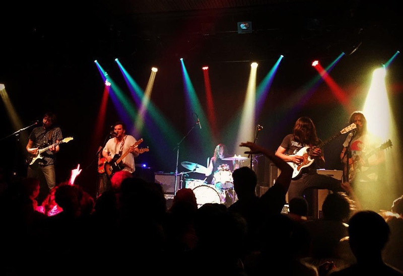 That's 4 electric guitars (the bassist is hidden behind
the 2nd from the left), and I like to think they are all "lead guitar", Spinal Tap style.
